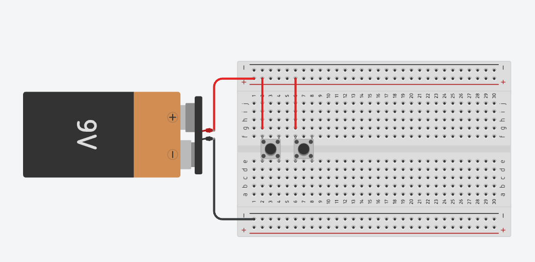 Powering both push buttons with red jumper wires to the top positive rail