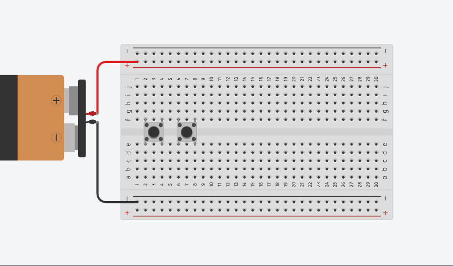 Placing two push buttons across the centre gap of the breadboard